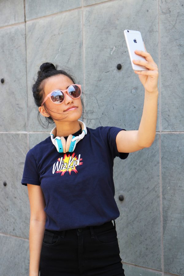 Model wearing navy wiz kid t shirt taking selfie