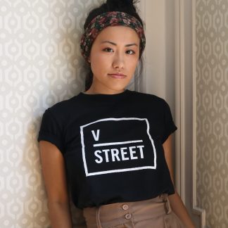 Model wearing black t-shirt with white v street logo
